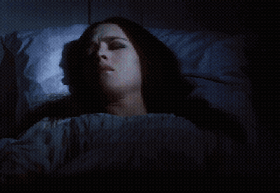 Woman With Cross Necklace Holding Head In Hands GIF
