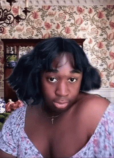 Woman With Cross Necklace Making Funny Face GIF