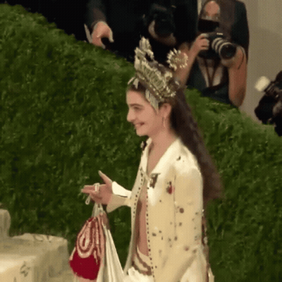 Woman With Crown Holding Bag GIF