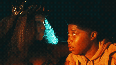 Woman With Crown Sits Next To Boy GIF