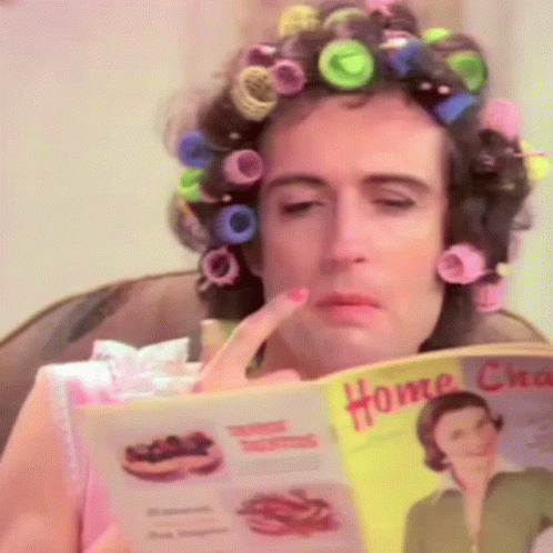 Woman With Curlers Reading Home Chores Magazine GIF