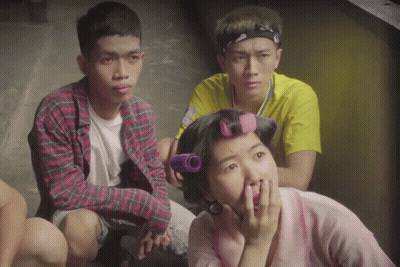 Woman With Curlers Sitting With Two Men GIF