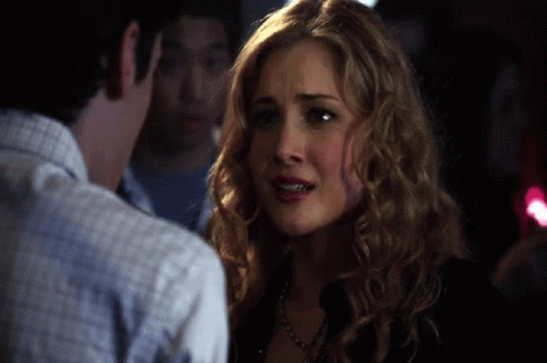 Woman With Curly Blonde Hair Looking At Man GIF