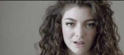 Woman With Curly Hair And Blue Eyes Making Funny Face GIF