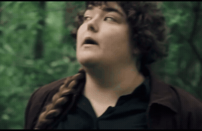 Woman With Curly Hair And Braid Looking Up At Sky GIF
