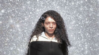 Woman With Curly Hair And Clip In Snow GIF