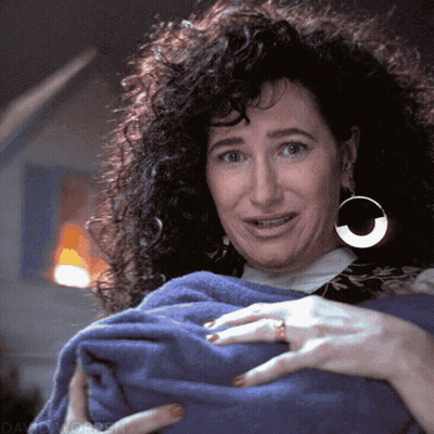Woman With Curly Hair And Hoop Earrings Holding Blue Towel GIF