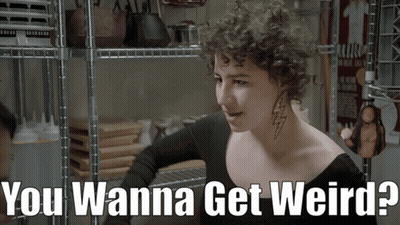 Woman With Curly Hair And Neck Tattoo Saying You Wanna Get Weird GIF