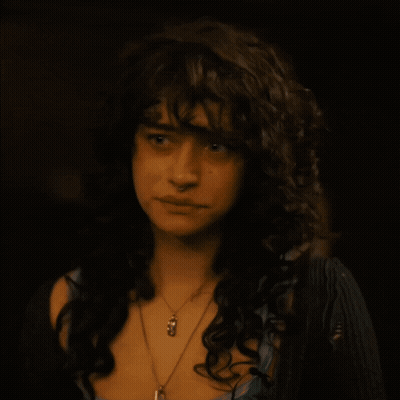 Woman With Curly Hair And Pendant Necklace GIF