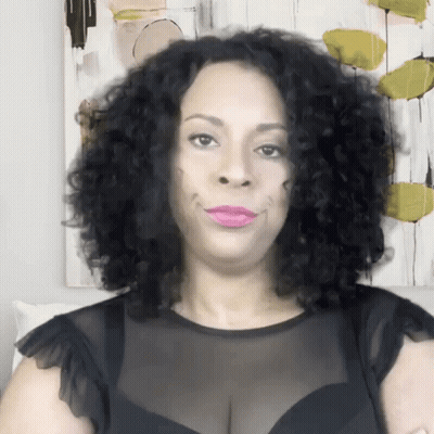 Woman With Curly Hair And Pink Lipstick In Black Top GIF