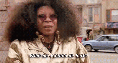 Woman With Curly Hair And Sunglasses Talking GIF