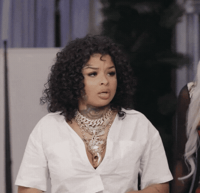 Woman With Curly Hair And White Shirt And Necklace GIF