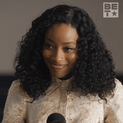 Woman With Curly Hair At Microphone GIF