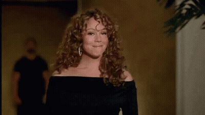 Woman With Curly Hair Blowing A Kiss GIF