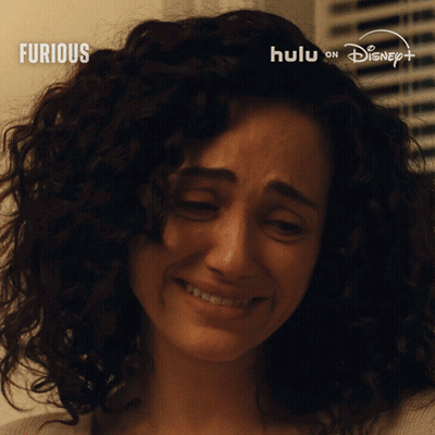 Woman With Curly Hair Crying In Front Of Furious Sign GIF