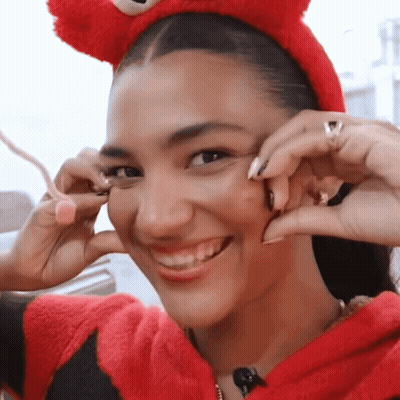 Woman With Curly Hair Drinking From Glass With Ring GIF