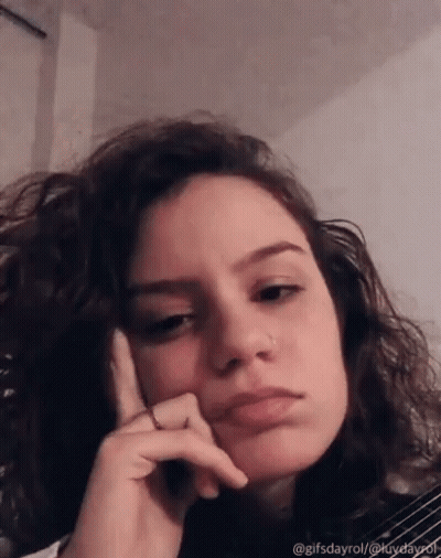 Woman With Curly Hair Funny Face Hand On Chin GIF