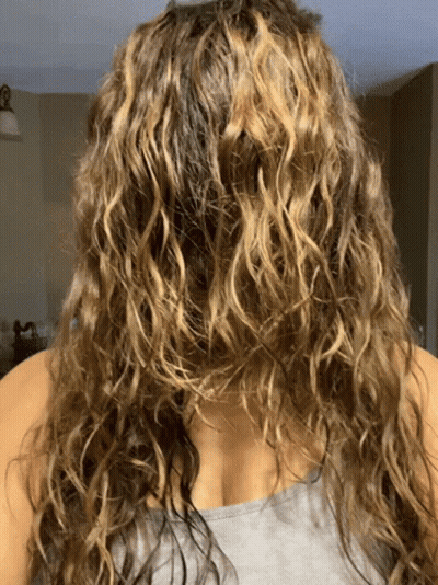Woman With Curly Hair In Gray Tank Top GIF