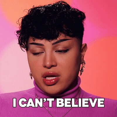 Woman With Curly Hair In Purple Turtleneck GIF