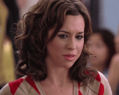Woman With Curly Hair In Red And White Sweater GIF