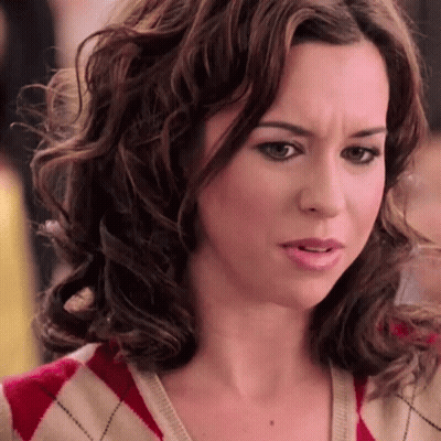 Woman With Curly Hair In Red And White Sweater GIF