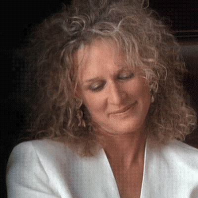Woman With Curly Hair In White Jacket GIF