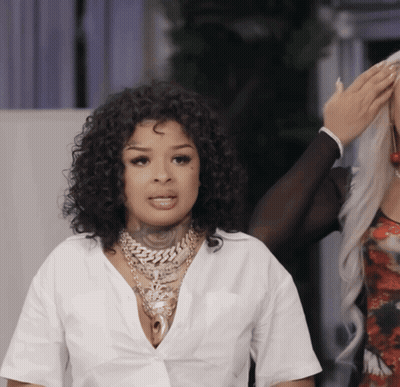 Woman With Curly Hair In White Shirt And Necklace GIF