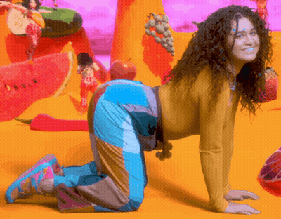 Woman With Curly Hair Kneeling On Floor GIF