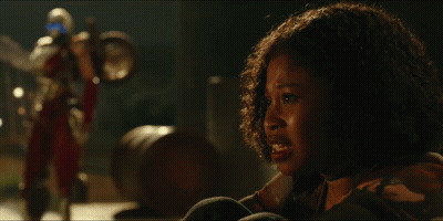 Woman With Curly Hair Looking At A Robot GIF