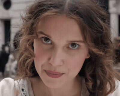 Woman With Curly Hair Looking At Camera GIF