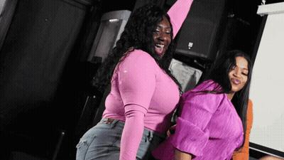 Woman With Curly Hair Looking At Man In Green Shirt GIF