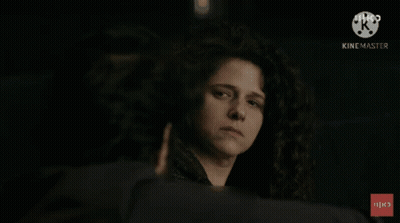 Woman With Curly Hair Looking At Man With Hebrew Text GIF