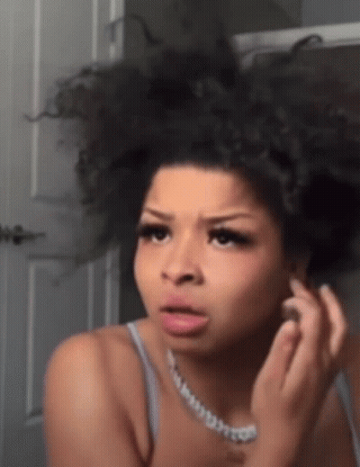 Woman With Curly Hair Looking In Mirror GIF