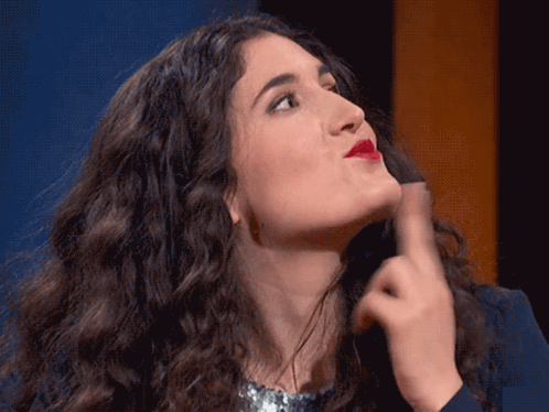 Woman With Curly Hair Making Face With Hand GIF