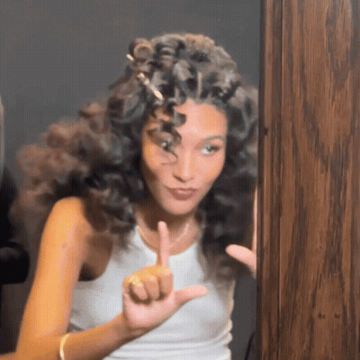 Woman With Curly Hair Making Funny Face GIF