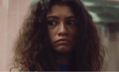 Woman With Curly Hair Making Funny Face GIF