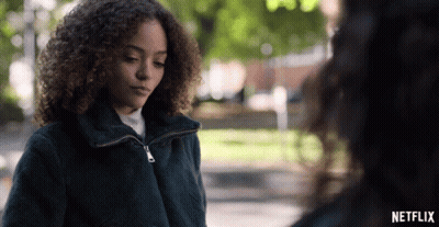 Woman With Curly Hair Next To Another Woman In Netflix Advertisement GIF