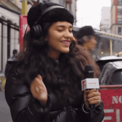 Woman With Curly Hair Pointing At Camera GIF