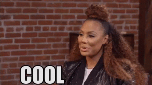 Woman With Curly Hair Saying Cool Beans By Brick Wall GIF