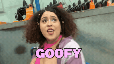 Woman With Curly Hair Says Goofy In Pink Font GIF