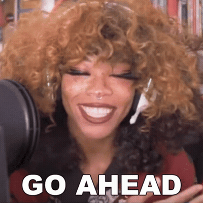 Woman With Curly Hair Smiling At Microphone Saying Go Ahead GIF