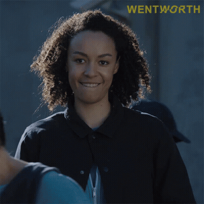 Woman With Curly Hair Smiling At Wentworth Sign GIF