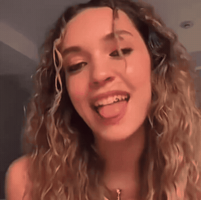 Woman With Curly Hair Sticking Tongue Out GIF