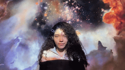 Woman With Curly Hair Surrounded By Purple Light GIF
