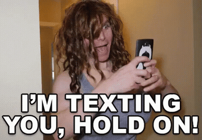 Woman With Curly Hair Taking Selfie Saying I'm Texting You Hold On GIF