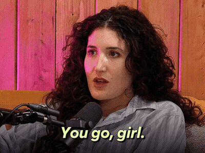 Woman With Curly Hair Talking Into Microphone GIF
