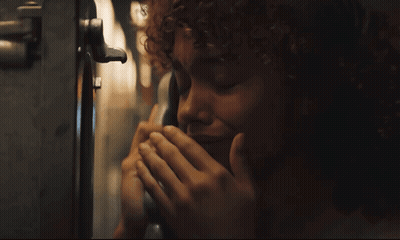 Woman With Curly Hair Talking On Phone GIF