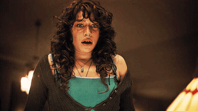 Woman With Curly Hair Wearing A Necklace Saying A GIF