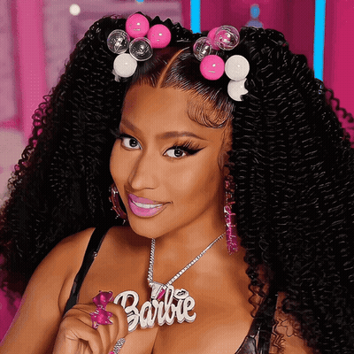 Woman With Curly Hair Wearing Barbie Necklace GIF