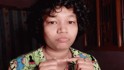 Woman With Curly Hair Wearing Snoopy Shirt GIF
